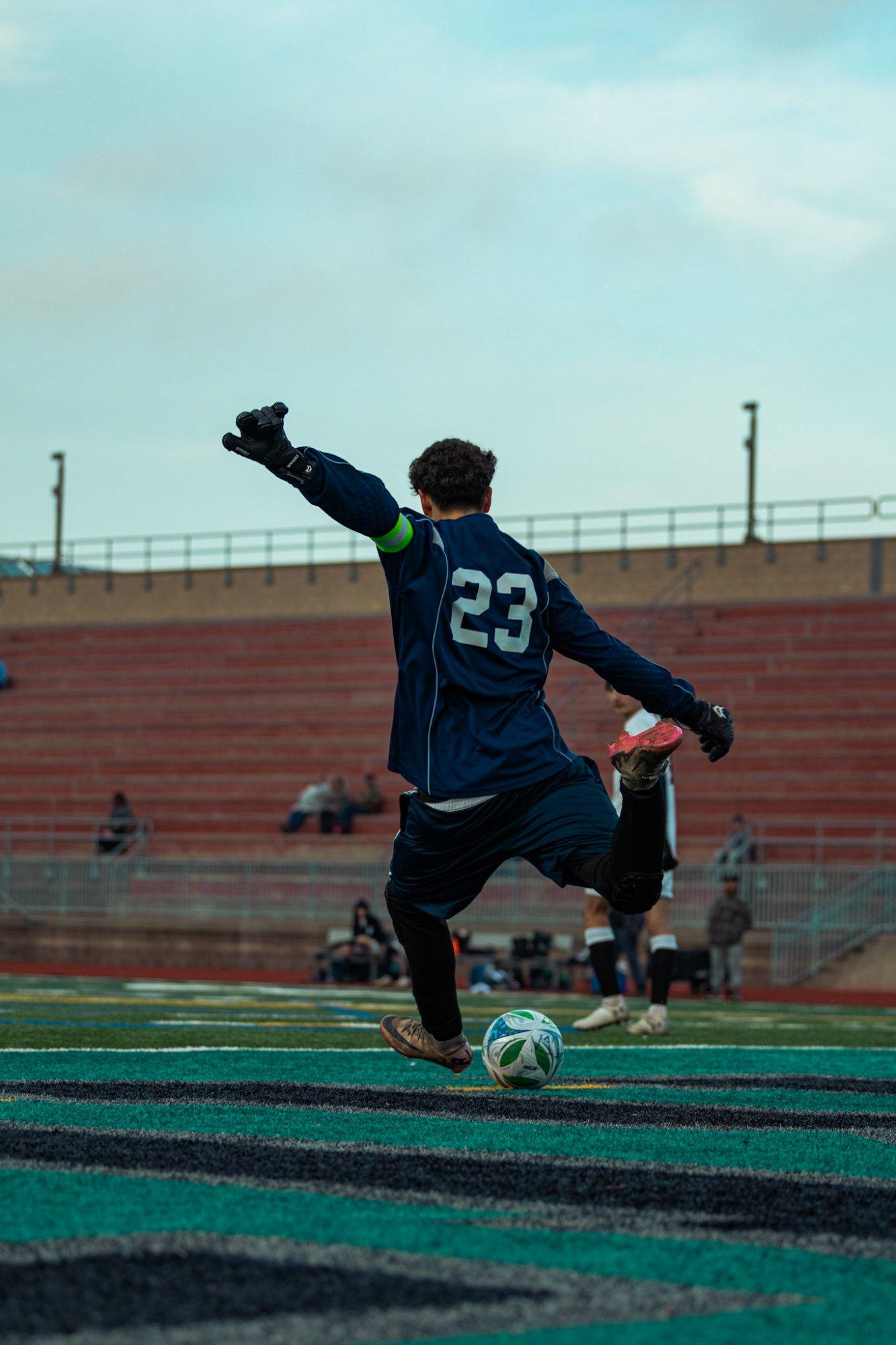 Goalkeeper striking a goal kick